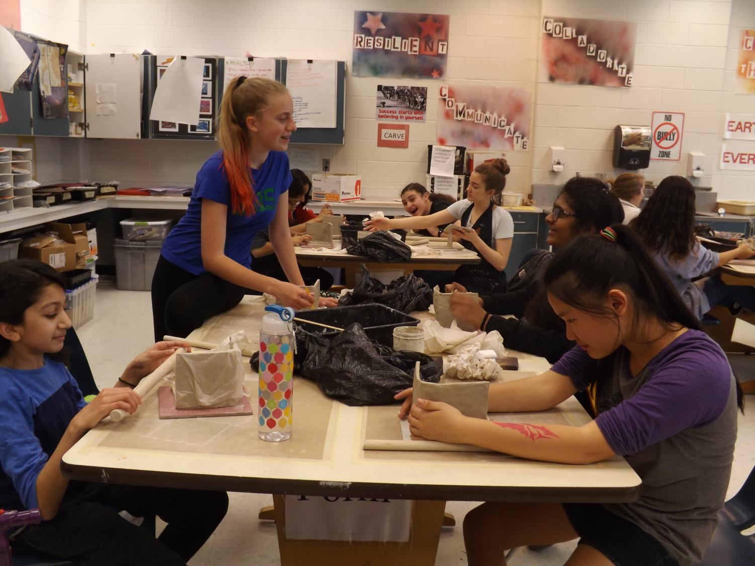 Students from Ms.Furpah’s 6th period Art Extensions class working on their family portraits metaphor, turning it into an object.