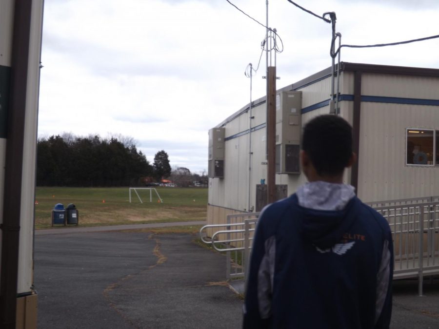 Jayson Bell, 13, of the X-Treme Team, walks to his class in the trailers.
