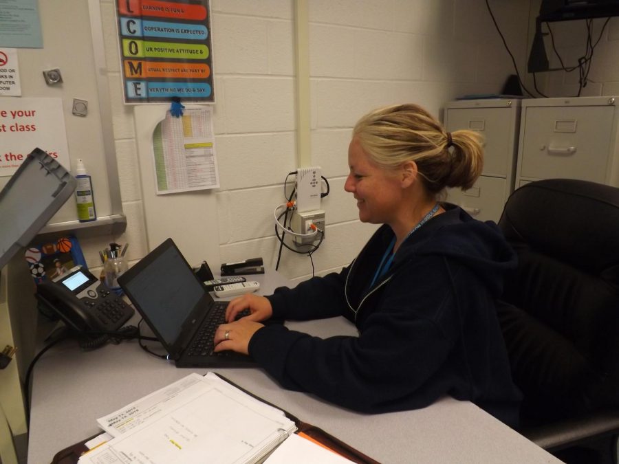 Ms. Rachel Cheng, teacher of RCMS elective Coding and Innovative Technology,  is working on her computer while students are doing work.