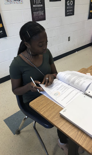 Kemberline Dunn, a seventh-grade ESOL student, works on science during Panther Time in Ms. Joyce’s room on May 3, 2019. 
