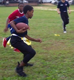 Two students go at it one on one in a flag football battle during after school hours on Rachel Carson’s field. 