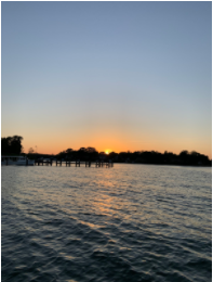 The image shows a sunset over the water. 