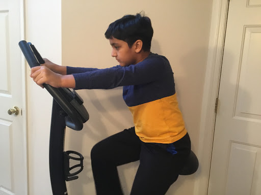 Anay Bansal exercises on his stationary bicycle during the pandemic.