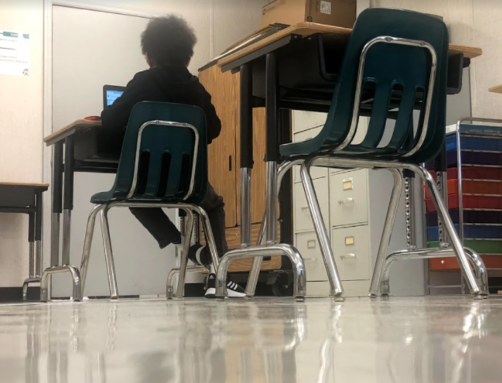 Seventh-grader+Anthony+Muse+works+on+his+computer+at+a+socially+distanced+desk