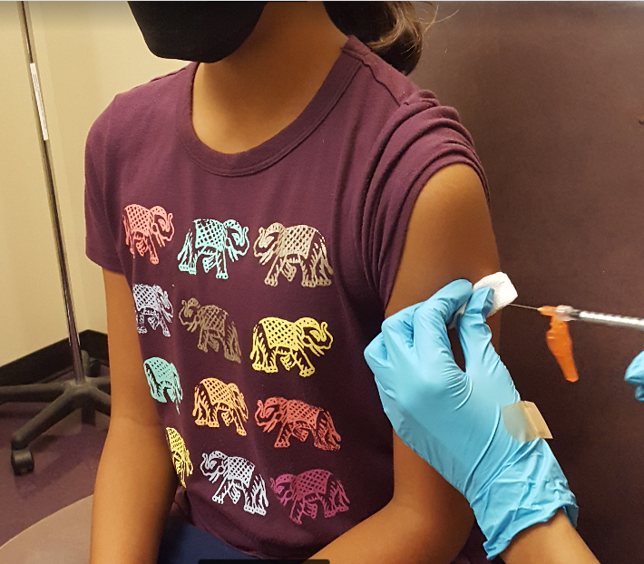 An RCMS student receives her first Covid shot after her 12th birthday.