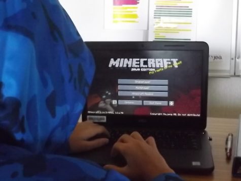 A student plays Minecraft on a school computer.