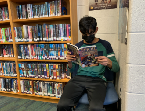 A student reading a Marvel comic book.