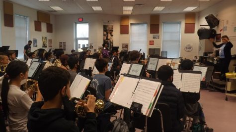Symphonic Band students playing Mystery and Mayhem while the Band Director, Ms. Tiffany Hitz, conducts.