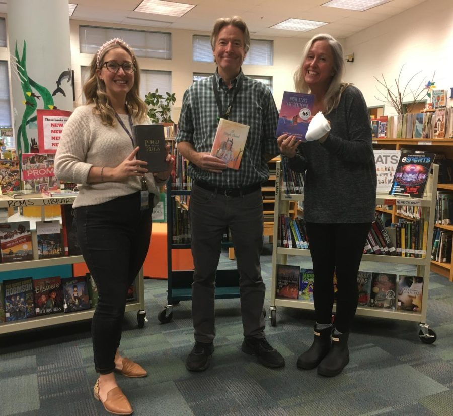 From left to right, Mrs. Donovan, Mr. Treakle and Mrs. Ross are holding their favorite books, on Monday, April 18, 2021, at the RCMS library.  