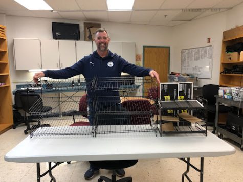 Mr. Pawlowski, the after-school program specialist, displays empty snack stands after having them all donated for spring break.