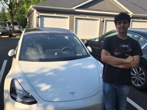 Harman Kumar, an eighth-grader on the Dolphins team, checks out a Tesla.