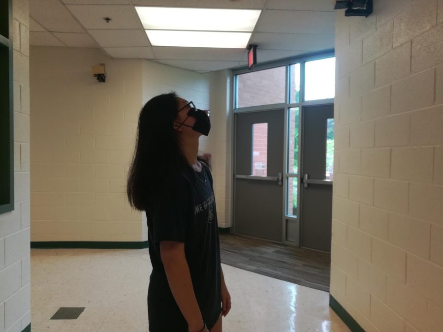 Alicia Zheng looking for potential locations of security camera placement. Photo credit: Hailey Deng