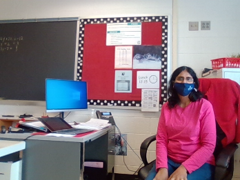 Ms. Sivakumar sits at her desk.