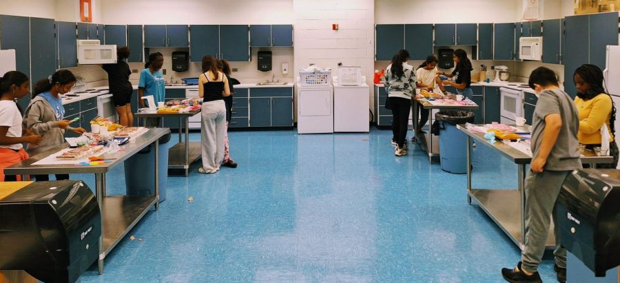 Students start working on their delicacies after directions for the new recipe are
given by Ms. Heather Sullivan, the Cooking club teacher.
