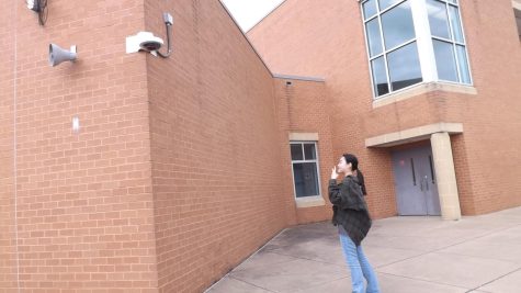 Eighth-grader, Emma-Grace Kim posing to outdoor security camera