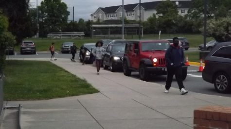 Rachel Carson students walk from the Kiss and Ride into the school