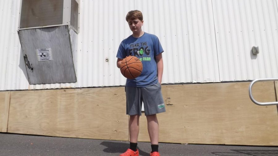 Westley Maxwell, an eighth-grader on the Dolphins Team dribbling a basketball