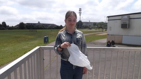 Seventh-grader, Anne Mitchell holds a plastic bag.