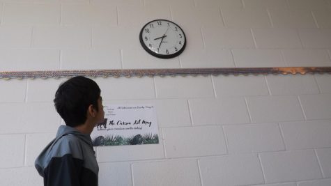 Veer Sawhney, seventh-grader, looks at a clock.