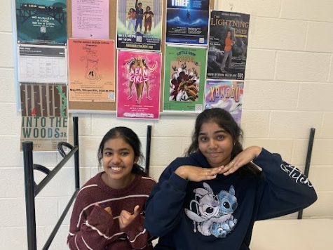 Shreya Rao and Tanmayi Vellanki in front of the freaky friday posters made by the musicals crew. 