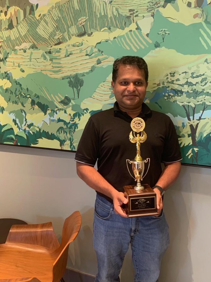 RCMS Science Olympiad Coach Raj Rai is holding the 4th place trophy the RCMS Science Olympiad team earned at the State tournament.