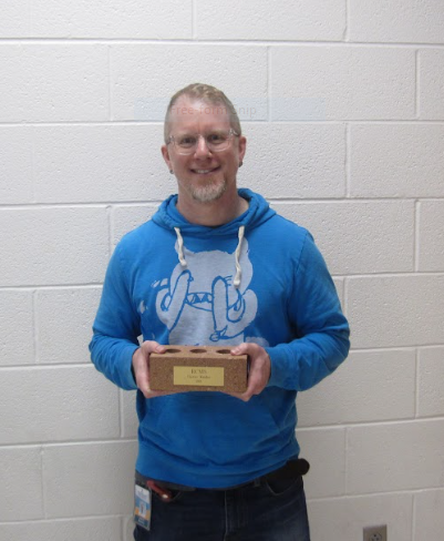 Mr. Bickford holding one of “the bricks” from when RCMS first opened that was left over from construction.