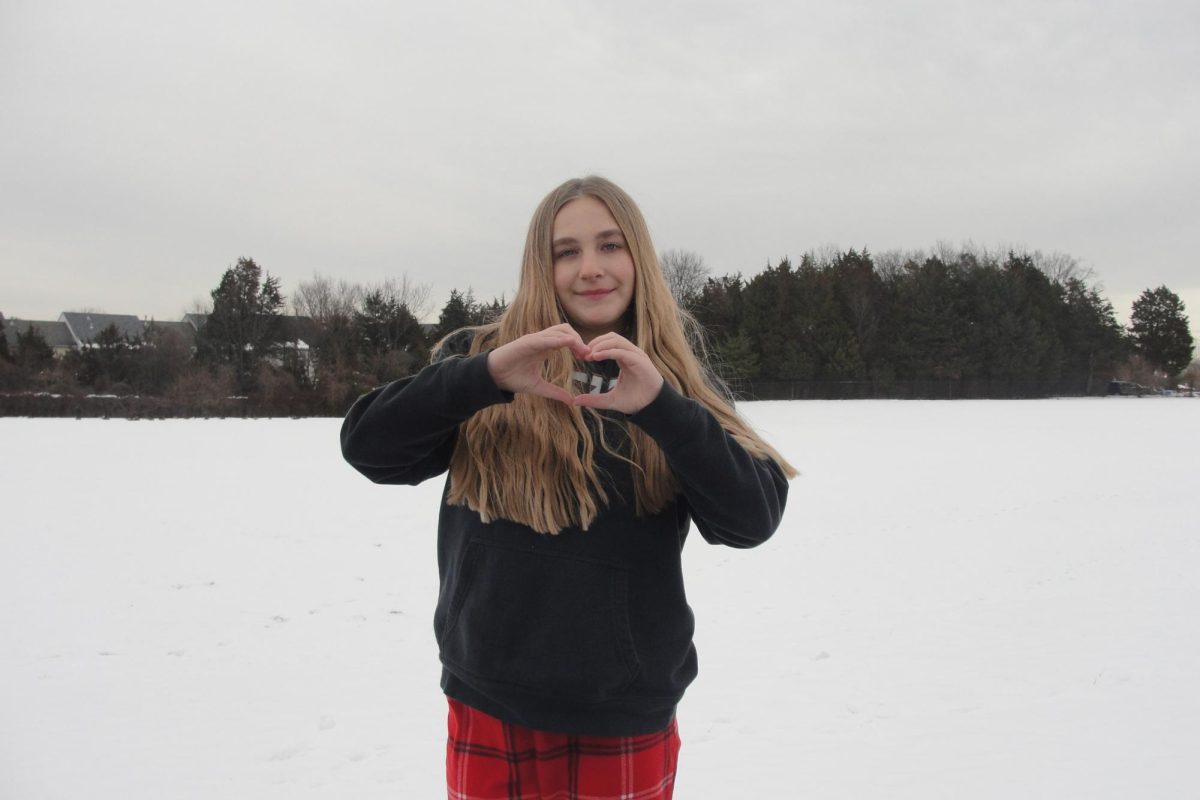 Emma Speckhardt making a heart in the snow.