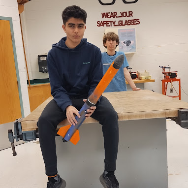 Arnav Nair, eighth-grader on the Wolves team, also the TARC team captain, holds one of the TARC rockets while mewing in pride.
