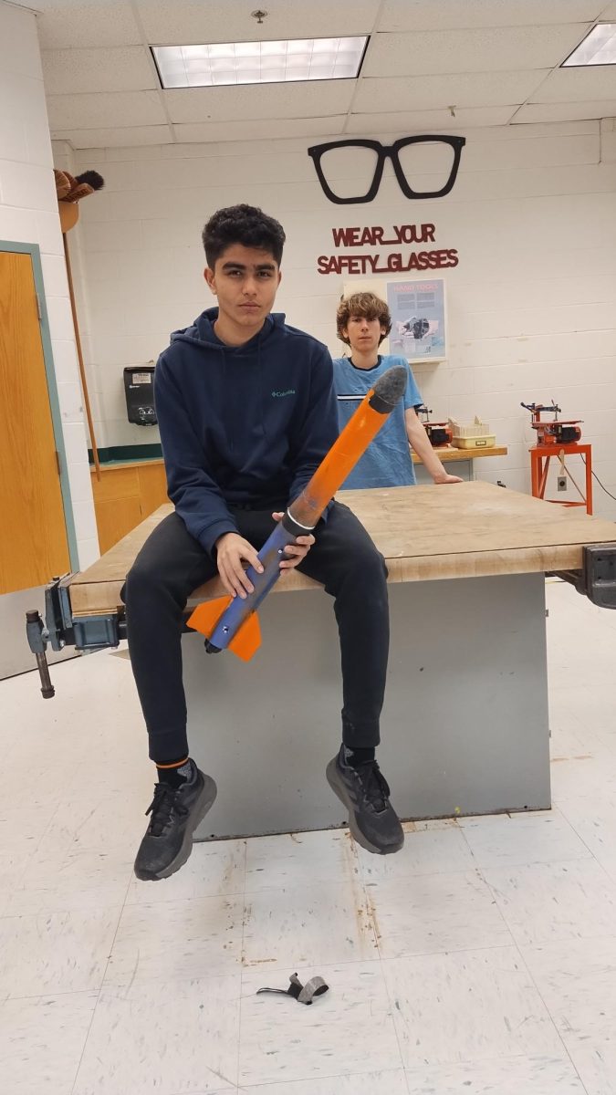 Arnav Nair, eighth grader on the Wolves team, also the TARC team captain, holding one of the TARC rockets while mewing in pride.


