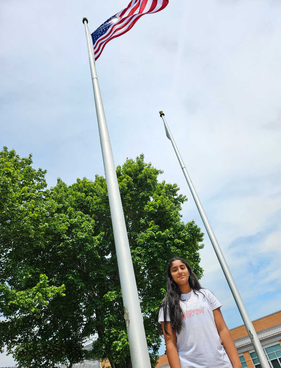 Rakshana+Damodaran%2C+an+eighth-grader+on+Dream+Team%2C+stands+in+front+of+the+American+flag.