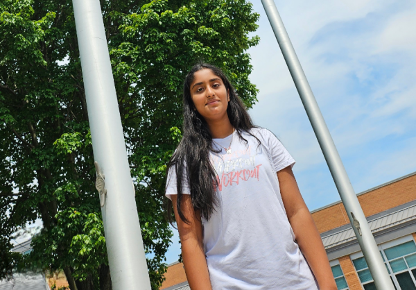 Rakshana Damodaran, an eighth-grader on Dream Team, stands in front of the American flag.
