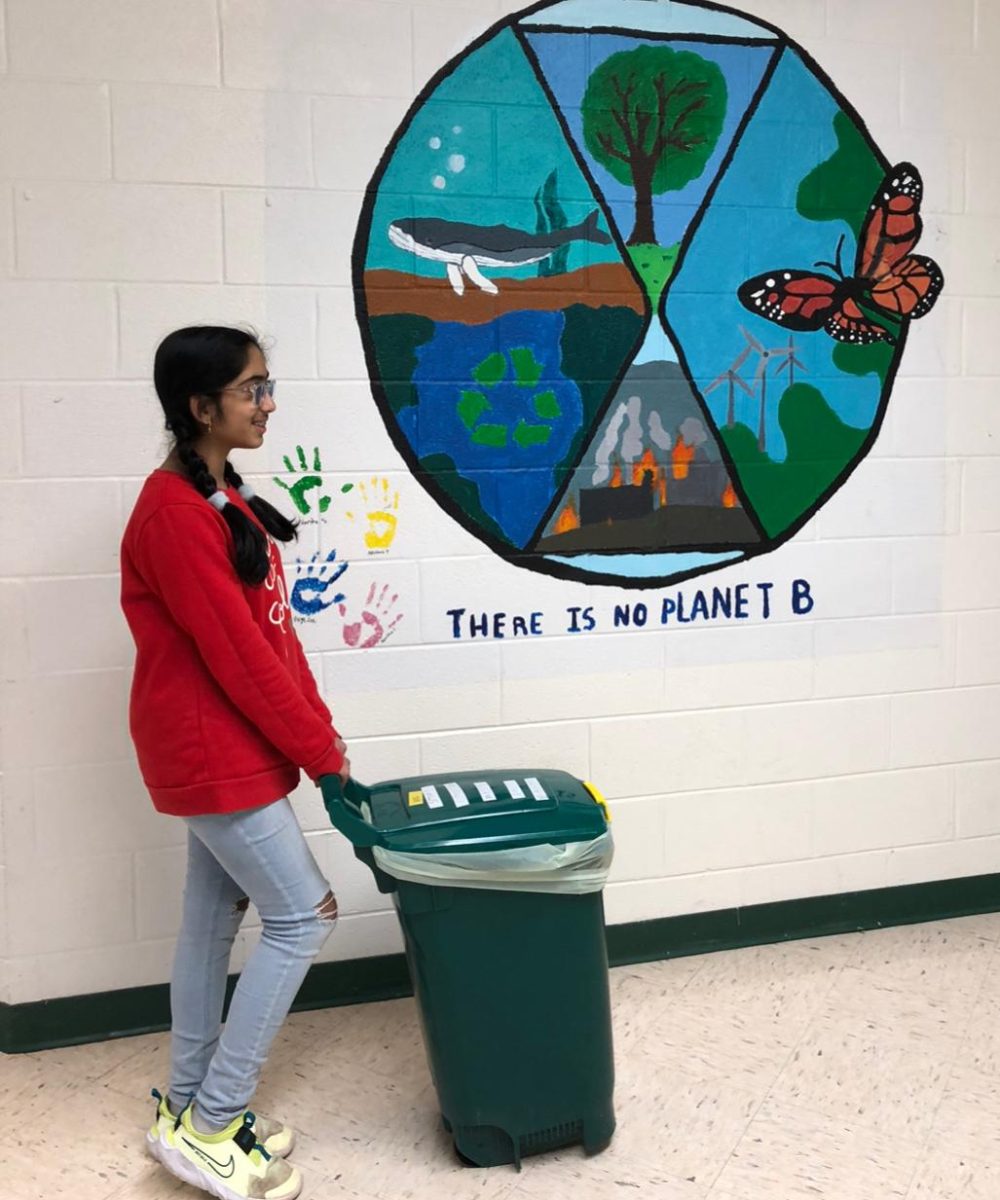 RCMS student, Radhika Deshpande, 12, of the Champions team, takes out a compost bin on April 25.