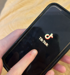 A student opens the TikTok app on their phone.