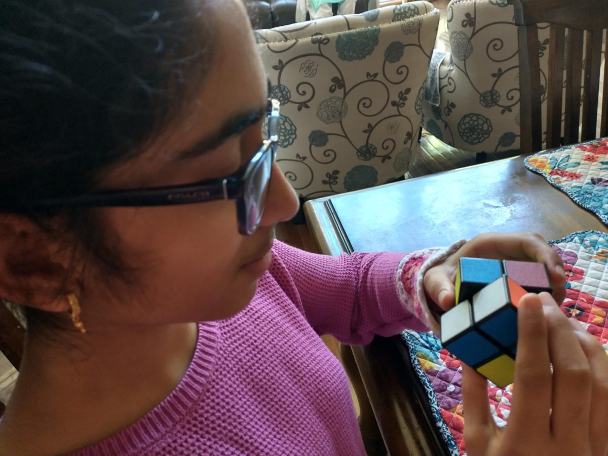 Radhika Deshpande,12, of the champions team practices solving the 2 by 2 Rubix Cube to prepare for the next competition 