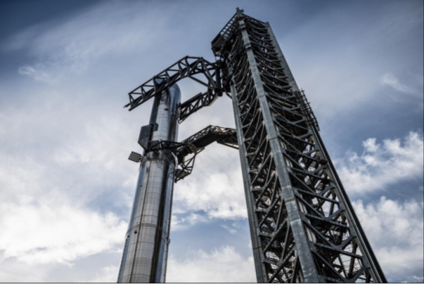 The rocket tower’s grid fins stack the Starship spacecraft onto the Super Heavy rocket booster at Starbase in Boca Chica, Texas. 
