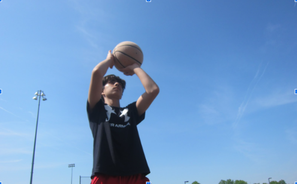 Suvan Sharma, 14 , on the Voyagers Team, shoots a basketball.
