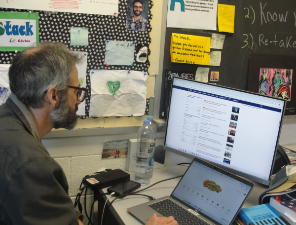 Mr. Stack looks over news articles on CBN about tariff related articles.
