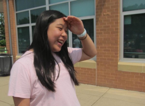 Amy Quach, 13, Dream Team, is conversing with friends in the sun.